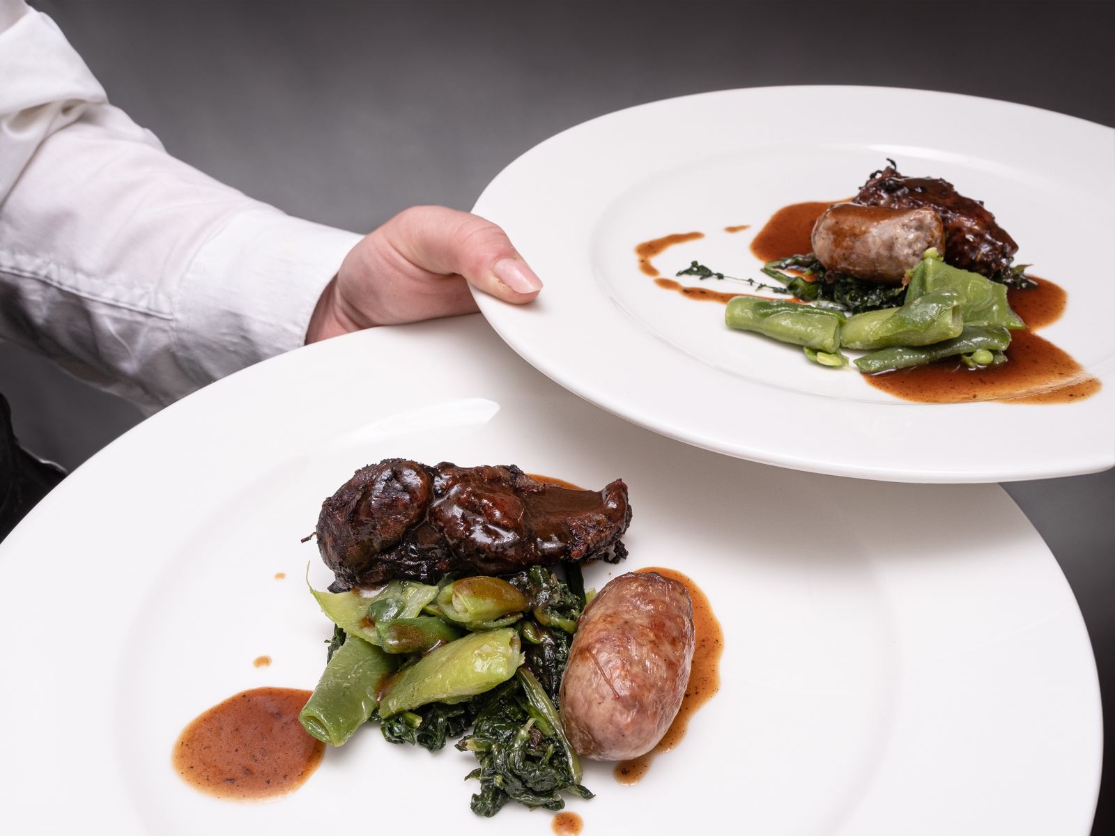 A Barcelona chef presenting plated dishes